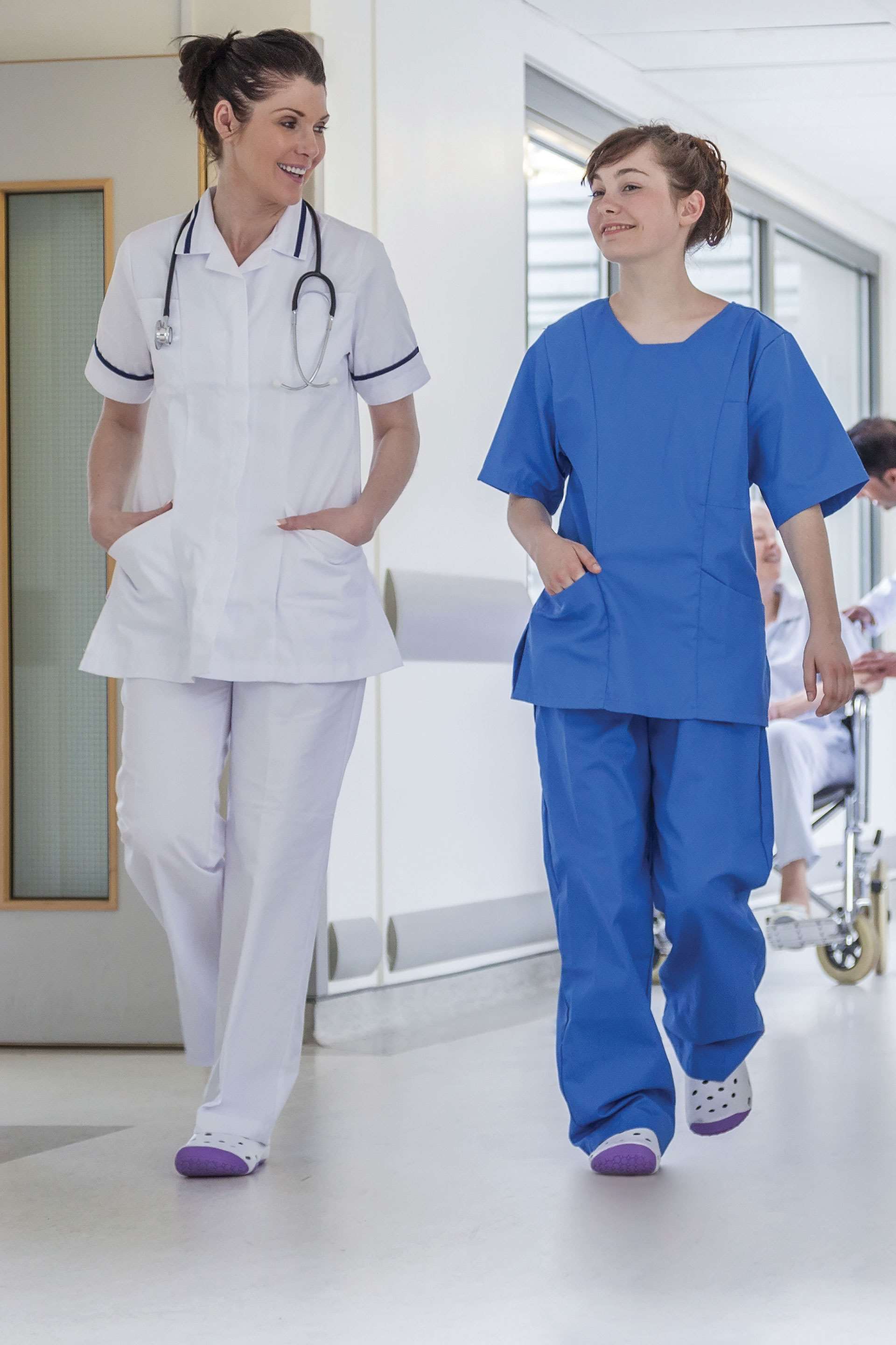 Two nurses walking down a hospital hallway